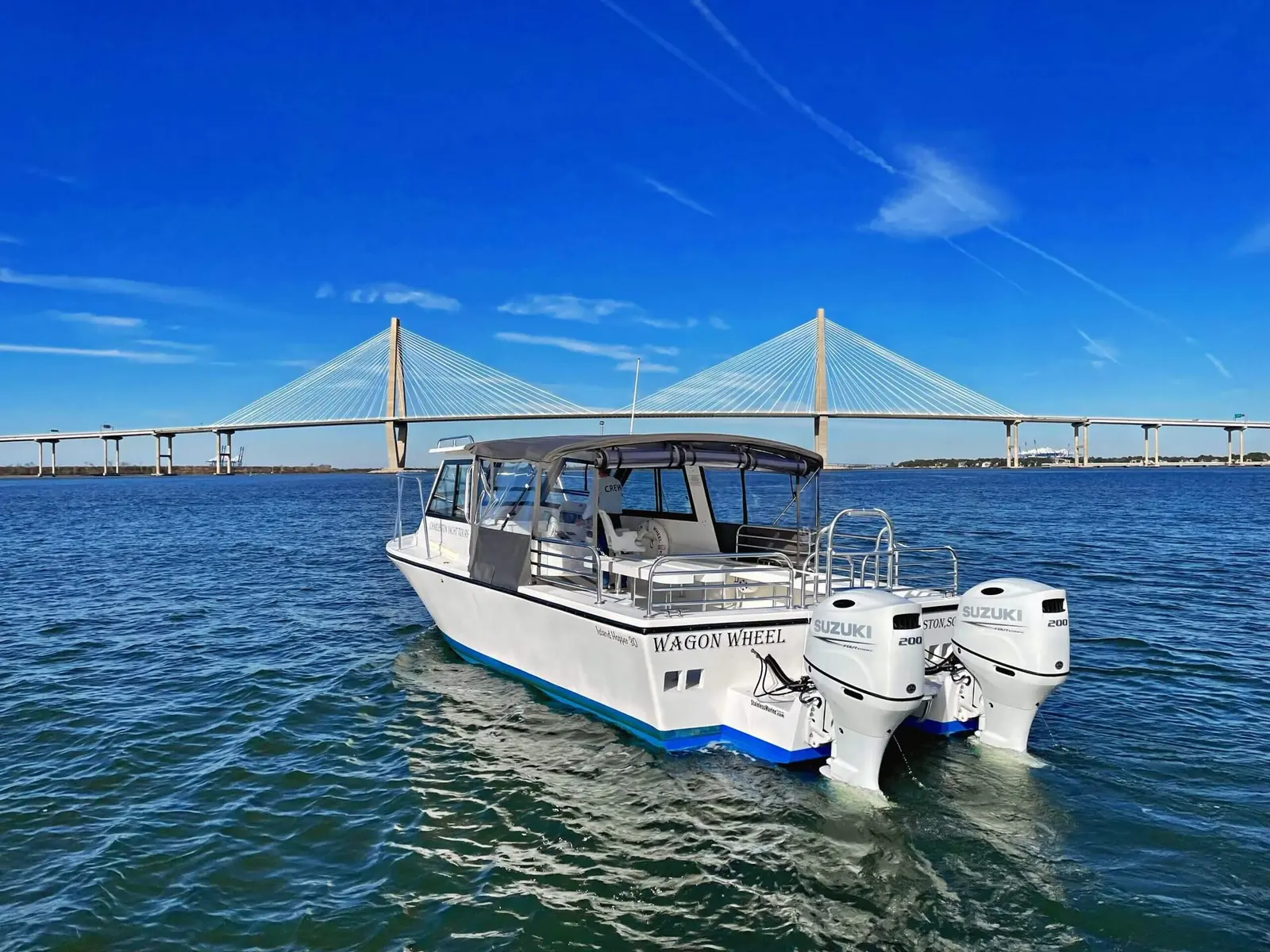Wagon Wheel charter boat crossing Charleston harbor beneath the Ravenel Bridge