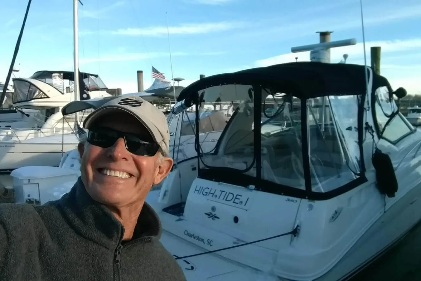 Captain Dan Stoll standing beside the High Tide I charter yacht