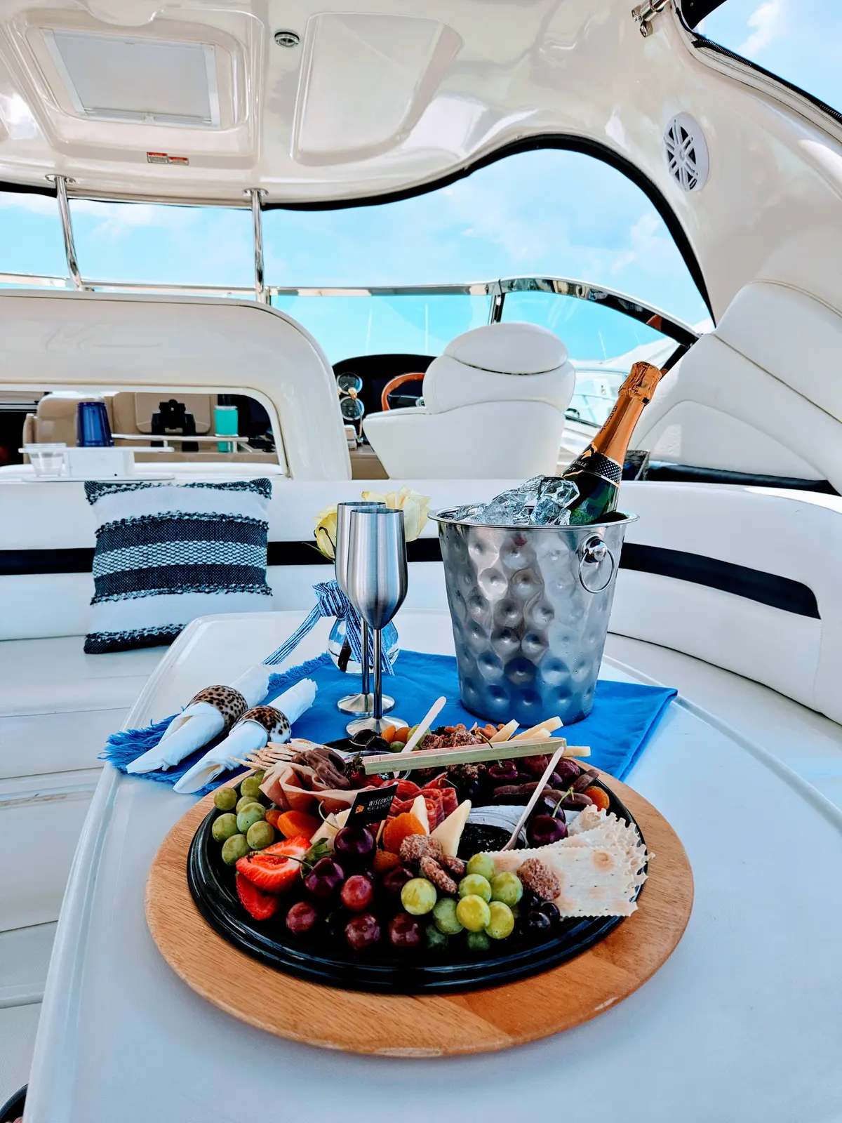 Champagne and a charcuterie spread set up on the deck of a Charleston charter yacht