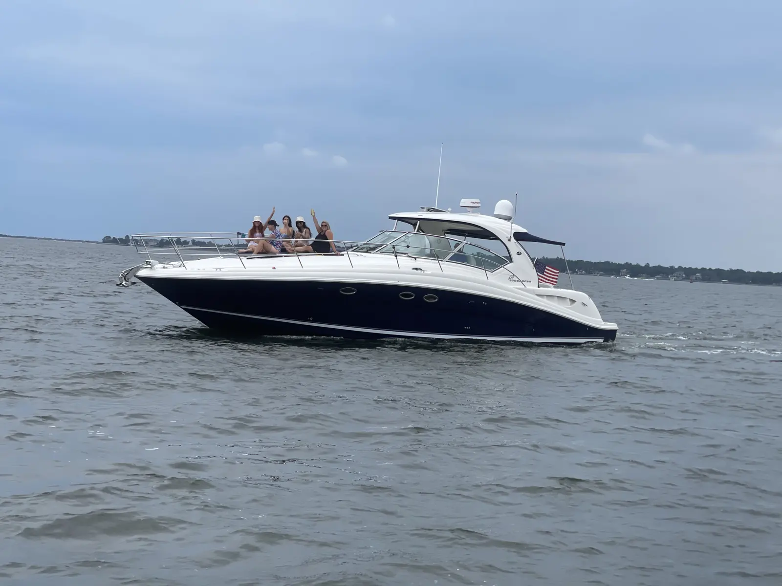 Guests waving from the bow of the High Tide charter yacht