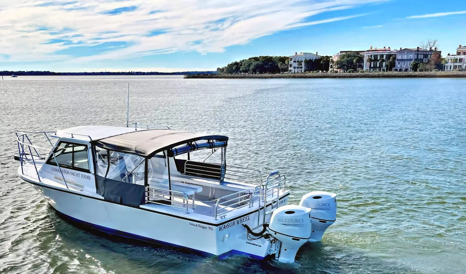 Wagon Wheel charter boat with the historic Charleston Battery homes behind it